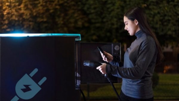 a woman uses ev charger